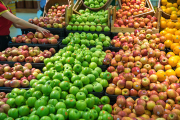 Fresh healthy fruits on shelves in supermarket