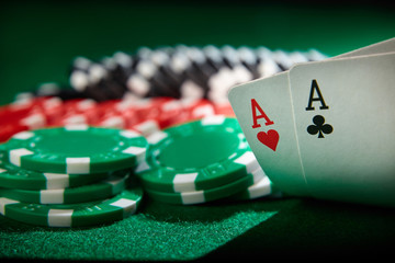 A pair of aces and chips on poker table. Winning hand.
