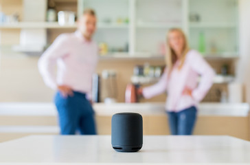 Couple using smart speaker at home
