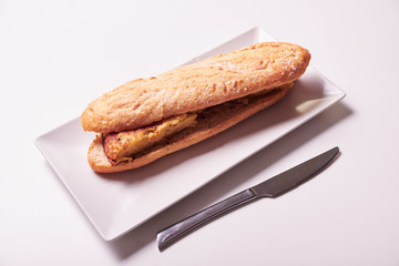 Tasty sandwich made of crispy baguette and tortilla