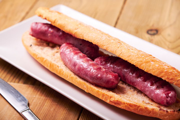 Tasty sandwich made of crispy baguette and sausages