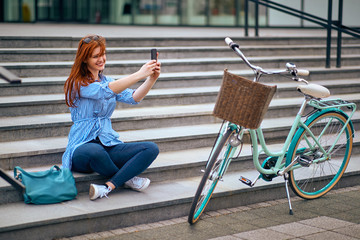 Female making photo on stairs in town