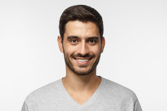 Smiling handsome man isolated on gray background