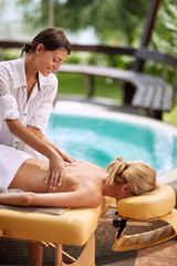 Fototapeta na wymiar woman at spa and wellness back massage treatment.