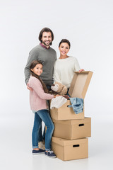 Fototapeta na wymiar Happy family with cardboard boxes moving to new house isolated on white