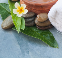 Obraz na płótnie Canvas Spa tropical flower and stones for relax massage treatment