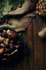 top view of fresh raw natural mushrooms, rope and sackcloth on wooden table