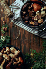 top view of various delicious raw mushrooms in pans and rope on wooden table