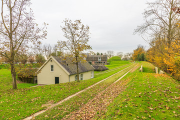 Obraz premium Earthen fortifications with concrete bunkers and wooden storage shed in Werk aan 't Spoel a fortress of the Nieuwe Hollandse Waterlinie