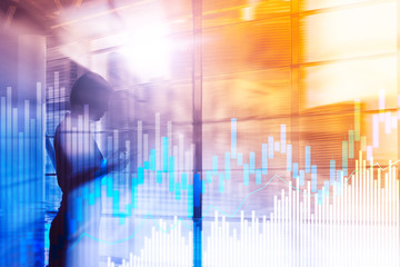 Stock trading candlestick chart and diagrams on blurred office center background.