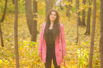 Season, fall and people concept - Portrait of young plus size woman outdoor on autumn background.