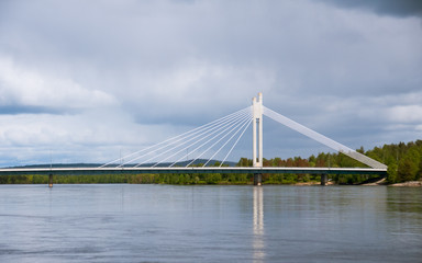 Fototapeta na wymiar Yatkianküntill bridge across the river Kemijoki, Rovaniemi, Finland