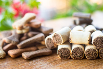 Dog tasty colored biscuits on wooden background, snacks for dogs
