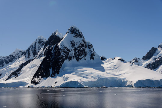 Antarctic landscape with mountains and reflection
