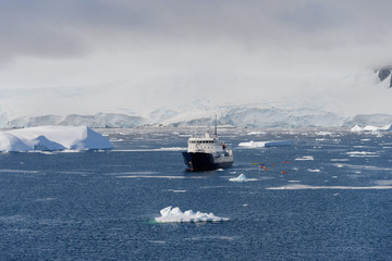 Antarctic landscape with expedition ship