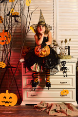 Little girl dreaming on halloween. Little girl make a halloween wish. Dreaming child in halloween...