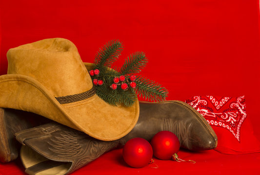 Cowboy Christmas card.American West traditional boots and hat on christmas  red background Stock Photo | Adobe Stock