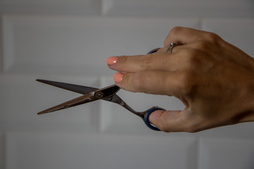 Hand of a women hairdresser with scissors 