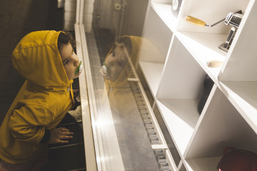 Little Girl Looking at a Showcase