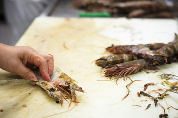 Cleaning tiger shrimps in the restaurant