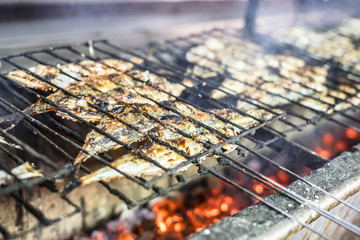 Small fish barbequed on charcoal