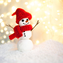 Festive Christmas background with snowman on the snow