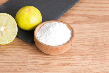 baking soda and lemon on wooden table