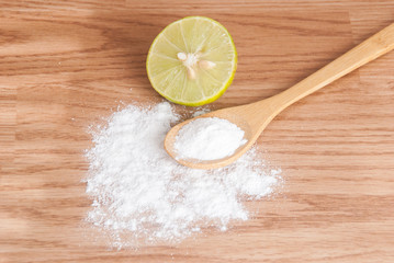 baking soda and lemon on wooden table