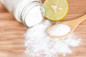 baking soda and lemon on wooden table