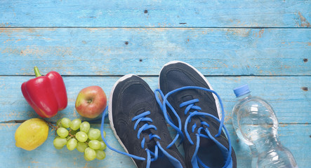 Getting fit and reducing weight for the springtime, pair of runners and healthy food,free copy space,flat lay