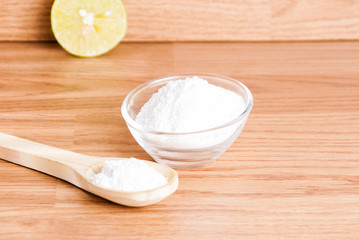 baking soda and lemon on wooden table