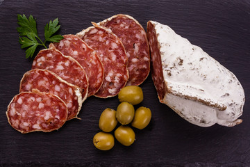 Saucisson sec delicious french salami on a wooden background