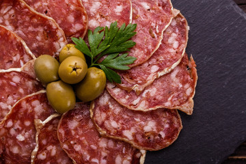 Saucisson sec delicious french salami on a wooden background