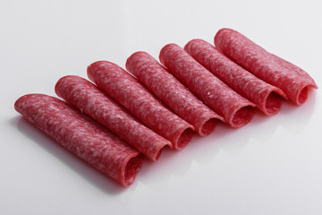 delicious sliced salami on a white background