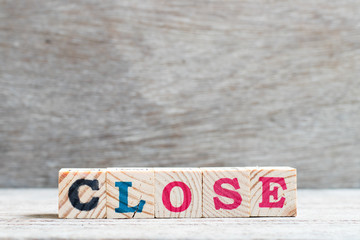 Letter block in word close on wood background