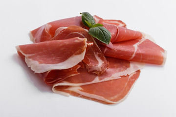 Italian prosciutto crudo or spanish jamon on a white background