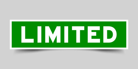 Green color label sticker in word limited on gray background