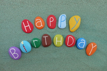 Happy Birthday postcard idea with colored stones over green sand