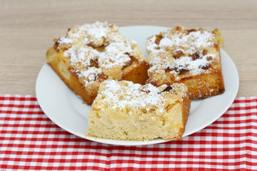 apple cake and apple standing on table