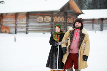 Couple in traditional winter costume of peasant in russia