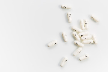 Capsules with painted emotions on a white background.
