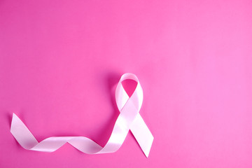 The pink colored ribbon - international symbol of breast cancer awareness and moral support for...