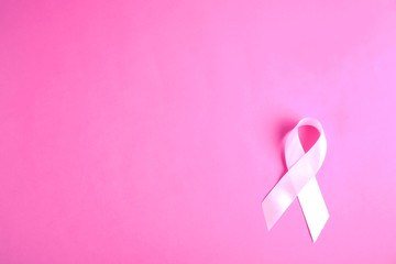 The pink colored ribbon - international symbol of breast cancer awareness and moral support for...