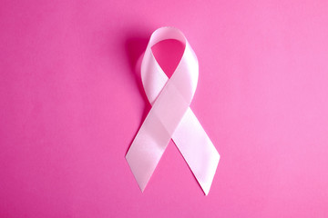 The pink colored ribbon - international symbol of breast cancer awareness and moral support for...