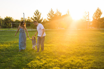 Friendly family walking in the park and have fun together