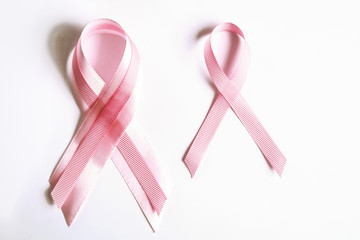 The pink colored ribbon - international symbol of breast cancer awareness and moral support for...
