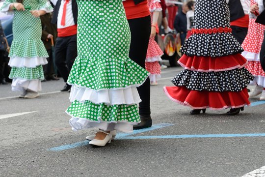 people in Spanish carnival costumes on the street