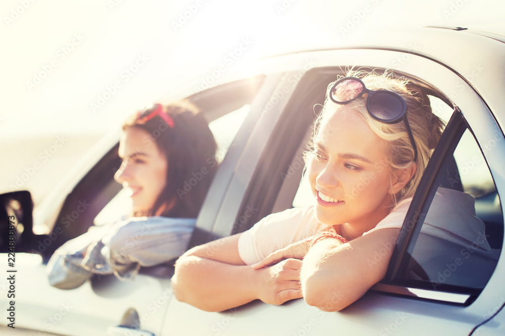 Canvas Prints summer vacation, holidays, travel, road trip and people concept - happy teenage girls or young women in car at seaside