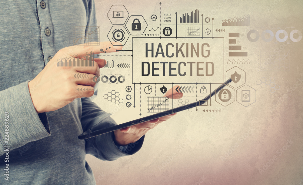 Poster hacking detected with man holding a tablet computer
