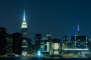 Obraz premium Long time exposure of New York City Manhattan midtown skyline at night viewed from Transmitter Park